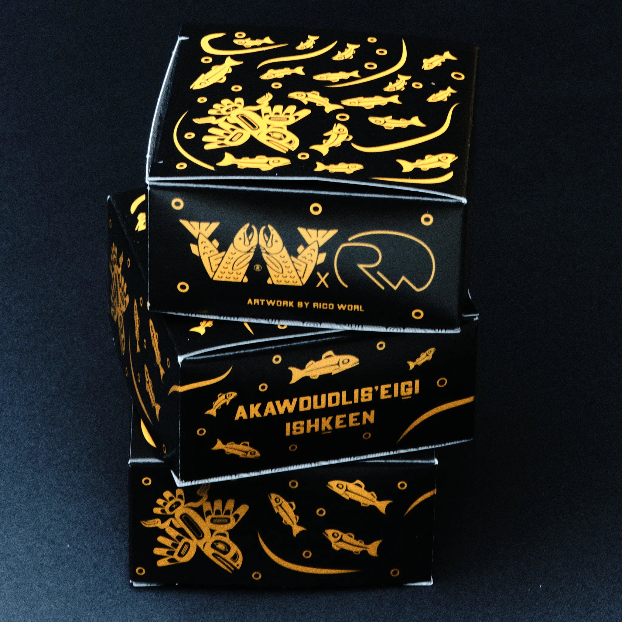 Black and gold packaging with intricate designs on a dark background