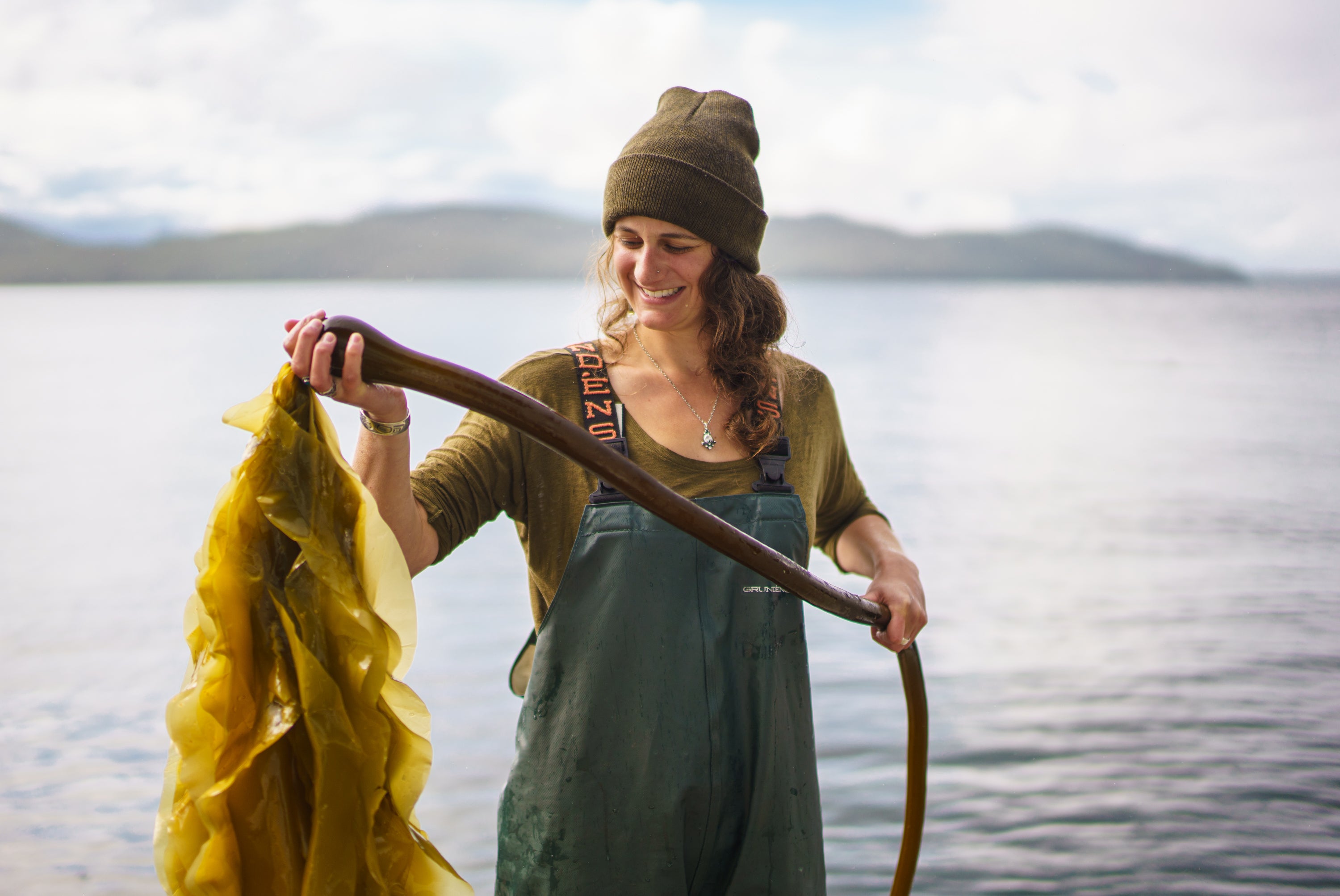 Woman holding piece of bullwhip kelp