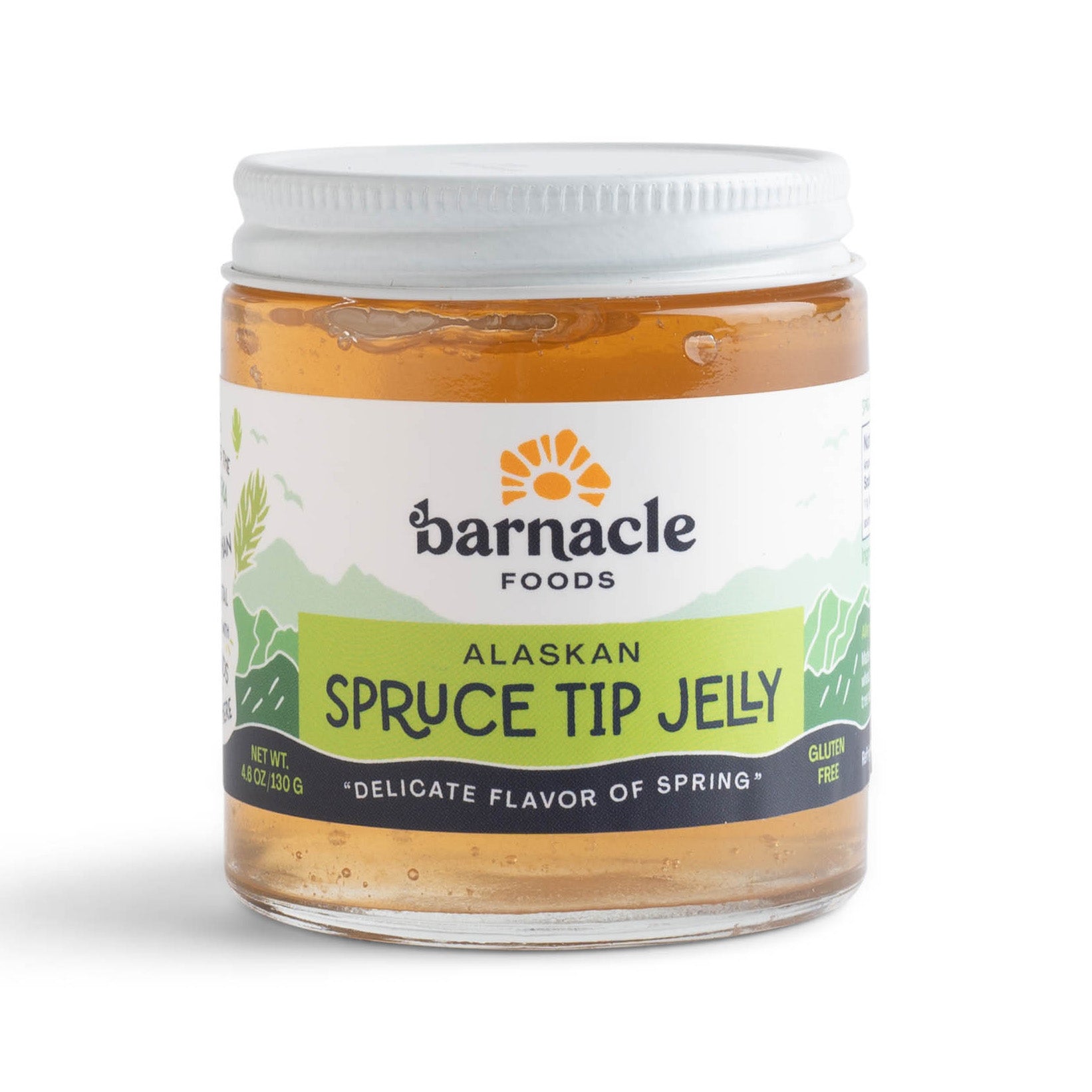A jar of 'Barnacle Foods Alaskan Spruce Tip Jelly' with a white lid on a plain background.