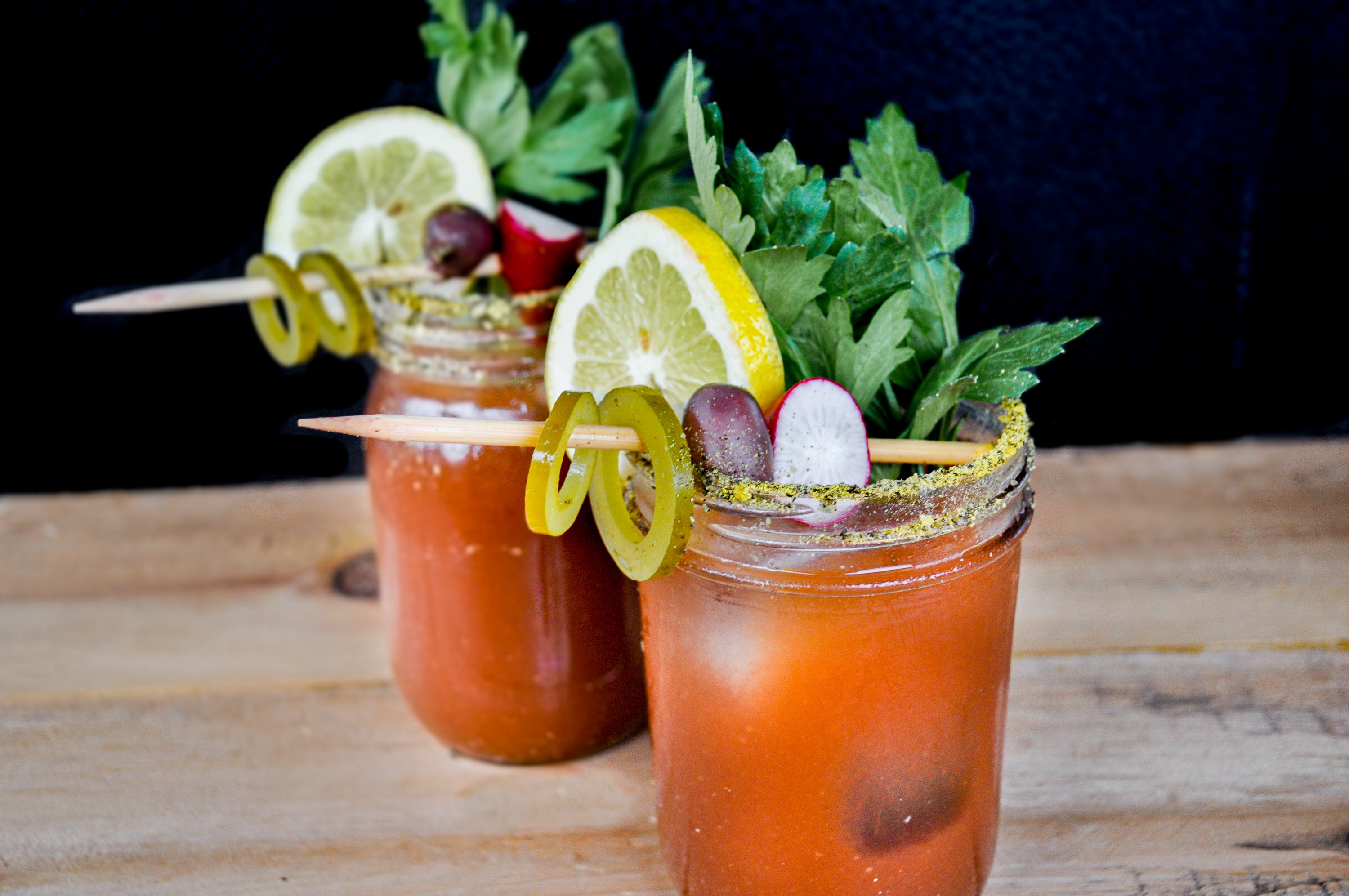 two bloody mary cocktails with garnish
